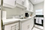 Modern kitchen styled w/ white marble countertops